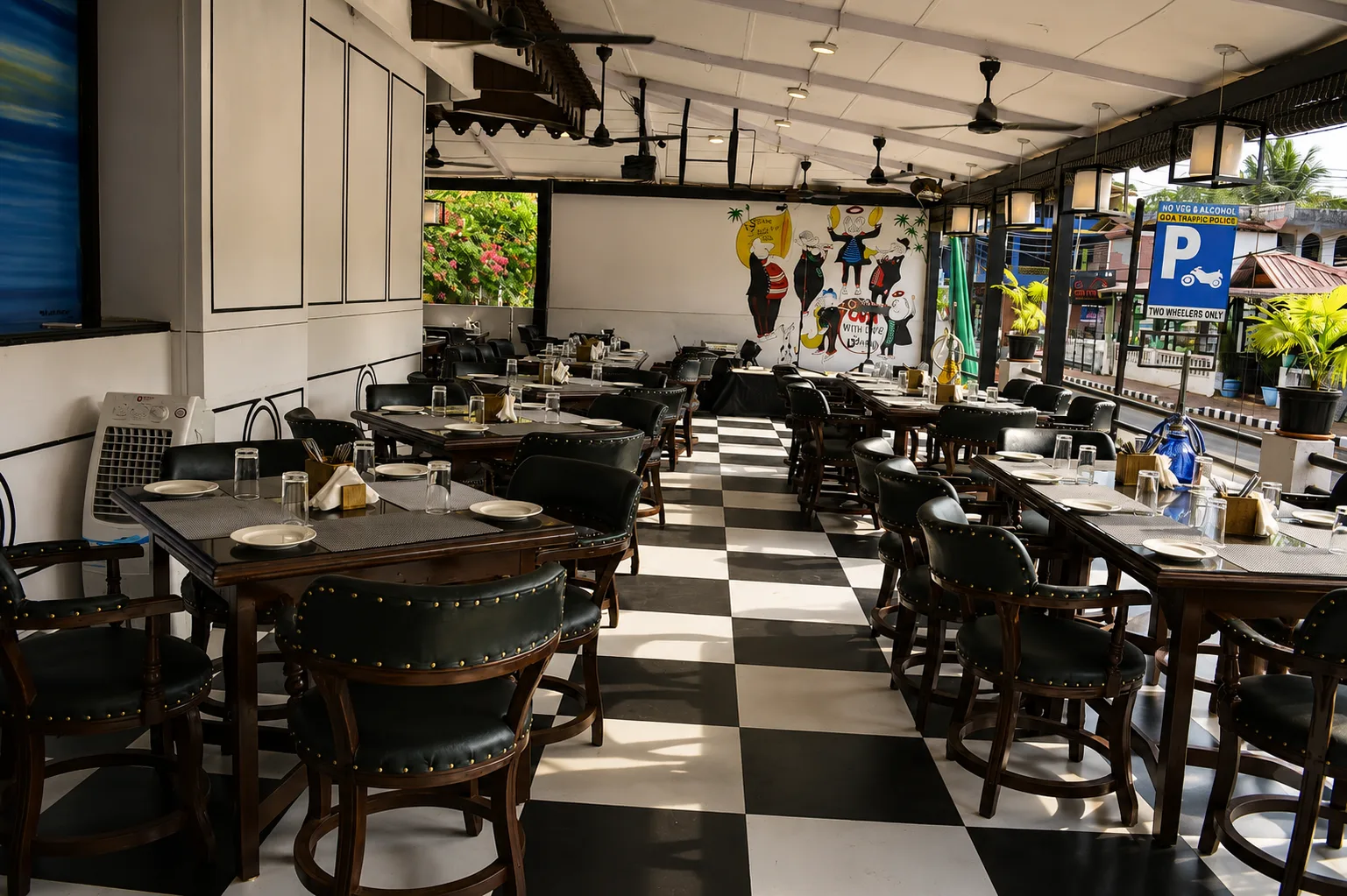 The ground-floor dining room in daylight, set tables on the chequered floor