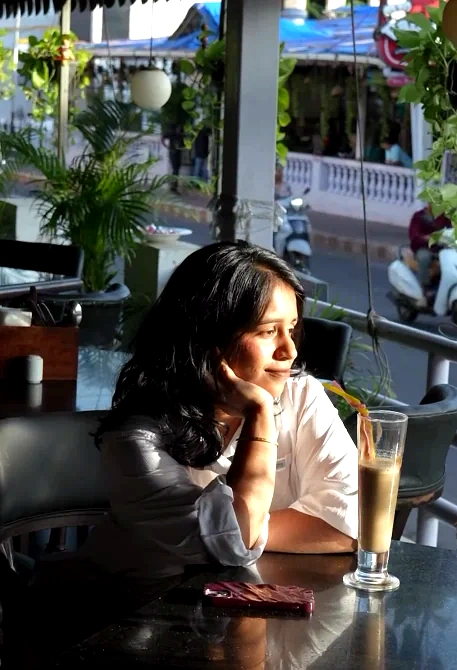 A guest at the window table, drink in hand