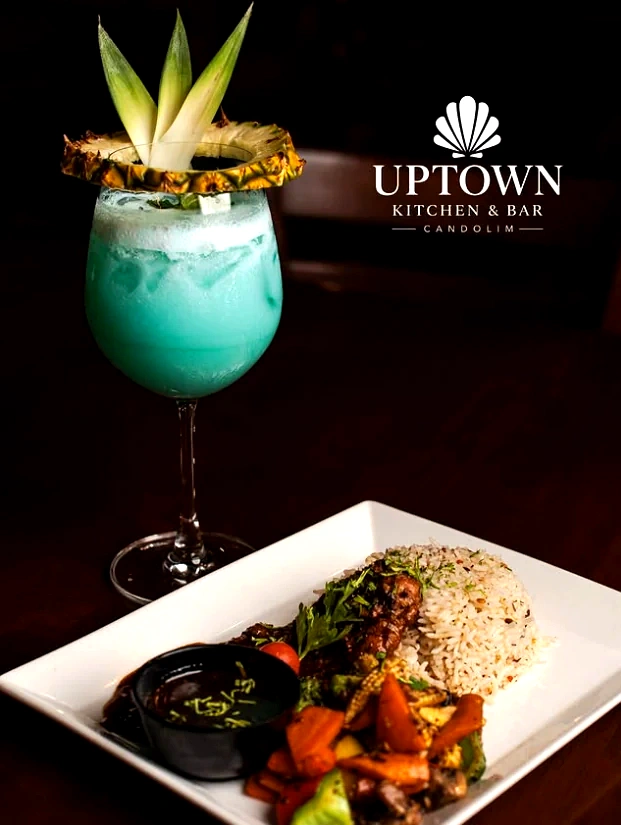 A cocktail and a plated main, ready on the pass